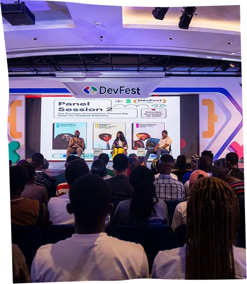 A wide view of Panel Session 2 on the DevFest stage, seen from the back of a full auditorium.